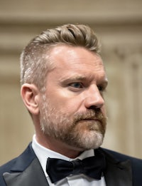 a man in a tuxedo with a beard